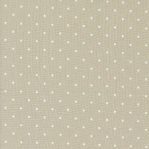 May include: A beige fabric with a white polka dot pattern.
