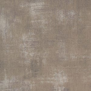 Pode incluir: Um tecido texturizado de cor castanho claro com um padrão subtil e desbotado. O tecido tem uma superfície ligeiramente áspera e irregular.