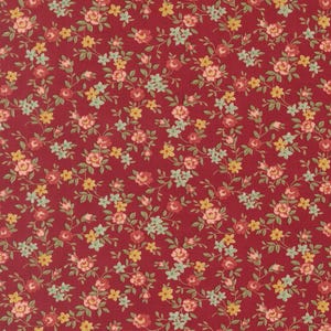 May include: A close-up of a fabric with a repeating floral pattern. The fabric has a deep red background with small, detailed flowers in shades of pink, yellow, and green. The floral design is evenly distributed across the fabric.