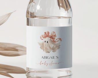 May include: Clear plastic water bottle with a white cap and a label. The label features a watercolor illustration of a ghost wearing a pink bow, with the text "ABIGAIL'S baby shower" in a delicate script.