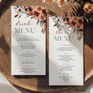 May include: Two rectangular menu cards with floral accents, one reading "Drink Menu" and the other "the Menu." The cards are on a woven tray, with floral arrangements in the background. The menus list drink and food options.