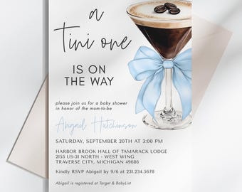 May include: A blue and white baby shower invitation with a coffee martini illustration. The text reads "A Tini One Is On The Way" and includes the date, time, and location of the event. The invitation also includes the name "Abigail Hutchinson" and the RSVP information.