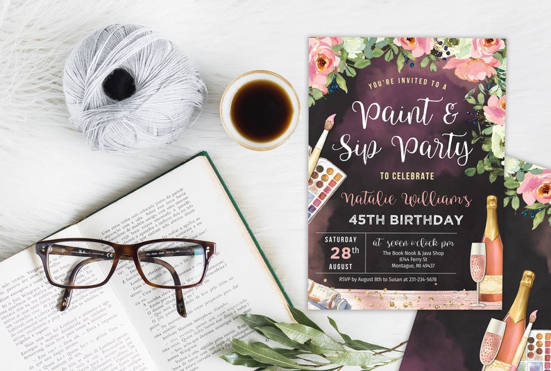 May include: A black and pink invitation to a paint and sip party to celebrate Natalie Williams' 45th birthday. The invitation features a watercolour background with floral accents, paintbrushes, and champagne glasses. The party is scheduled for Saturday, 28th August at 7:00 pm at The Book Nook & Java Shop in Montague, MI. RSVP by 18th August to Susan at 231-234-5678.