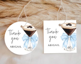 May include: Two thank you tags with a blue ribbon and a coffee cocktail illustration. The text on the tags reads "Thank you Abigail".