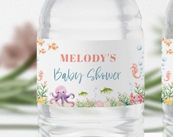 May include: Water bottle label with an under the sea theme. The label features an octopus, seahorse, starfish, and fish. The text on the label reads "Melody's Baby Shower".