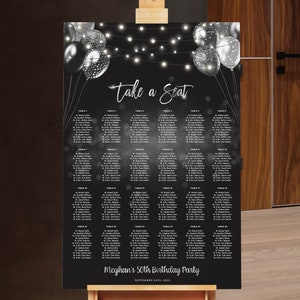 May include: Black and white seating chart with silver balloons and string lights. The text reads "Take a Seat" and "Meghan's 50th Birthday Party, September 20th, 2020".