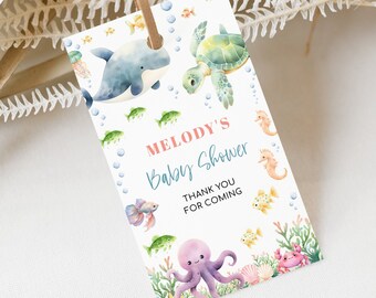 May include: A white thank you tag with a watercolor illustration of sea creatures. The tag says "Melody's Baby Shower" and "Thank You For Coming".