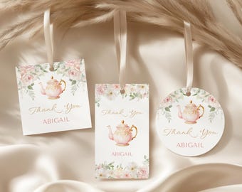 May include: Three gift tags with a watercolor design. Each tag features a pink teapot illustration, floral accents, and the text "Thank You ABIGAIL". The tags are in square, rectangular, and circular shapes.