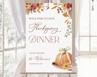 May include: A white sign with a watercolor design of fall leaves and a pumpkin. The sign says "Welcome to our Thanksgiving Dinner, Your Friends the Williamsons, November 28th, 20XX".