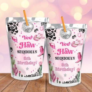 May include: Two pink and white juice pouches with a cow print design. The pouches feature a silver disco ball, pink cowboy hats, and pink cowboy boots. The text on the pouches reads "Yee Haw Sequoia's 5th Birthday!"