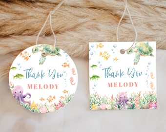 May include: Two thank you tags with a sea life theme. The tags are white with a blue border and feature a sea turtle, octopus, starfish, and other sea creatures. The text on the tags reads "Thank You Melody".