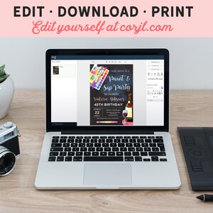 May include: A laptop computer displaying a website with a paint and sip party invitation. The invitation features a chalkboard background with colorful paintbrushes, a glass of wine, and the text "Paint & Sip Party" and "Valerie Gebyony 45th Birthday".