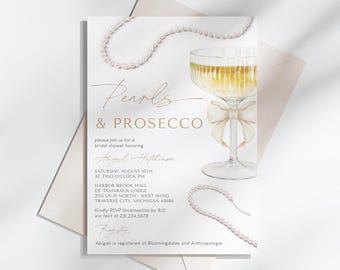 May include: A bridal shower invitation with a gold script font that reads "Pearls & Prosecco" and features a watercolor illustration of a champagne flute with a pearl necklace. The invitation includes the bride's name, the date, time, and location of the shower.