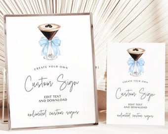 May include: Two printable signs with a watercolor illustration of a coffee cocktail with a blue ribbon. The text on the signs reads "Create your own Custom Sign. Edit text and download. Unlimited custom signs."