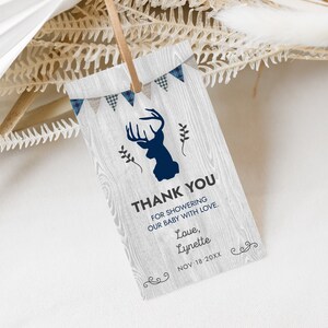 May include: A rustic thank you tag with a blue and white plaid pattern, a silhouette of a deer, and the text "THANK YOU FOR SHOWERING OUR BABY WITH LOVE. Love, Lynette NOV-18-20XX".