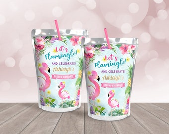 May include: Two pink and white juice pouches with a tropical flamingo theme. The pouches have a blue background with pink flamingos, green leaves, and yellow flowers. The text on the pouches reads "Let's Flamingle! And Celebrate! Ashleigh's Second Birthday!"