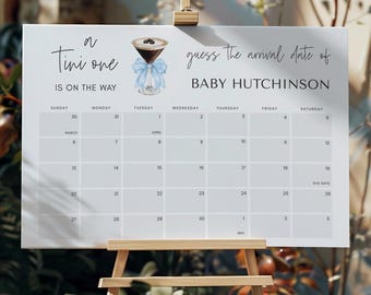 May include: A white calendar with a blue ribbon and a glass of coffee with a blue ribbon. The calendar is for guessing the arrival date of Baby Hutchinson. The calendar is for March, April, and May.