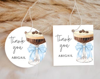 May include: Two round thank you tags with a coffee drink illustration and the text "Thank you Abigail". The tags are white with a blue ribbon.