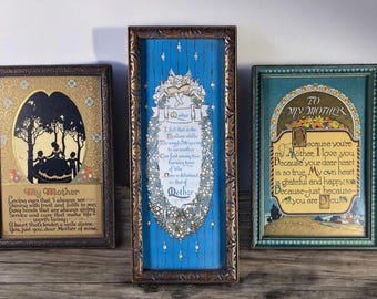 May include: Three framed vintage prints with blue and gold accents. The prints feature poems about mothers with illustrations of flowers, angels, and silhouettes of people under a tree.