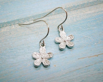 Matt Rhodium Plated Small Flower Pendant On Rhodium Plated French Earring Hooks.