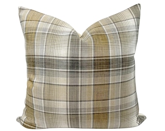 May include: Square cushion featuring a plaid design in beige, olive green, and black. The cushion has a soft, textured look and a neutral colour scheme, suitable for various home decor styles. Measures approximately 45cm x 45cm.