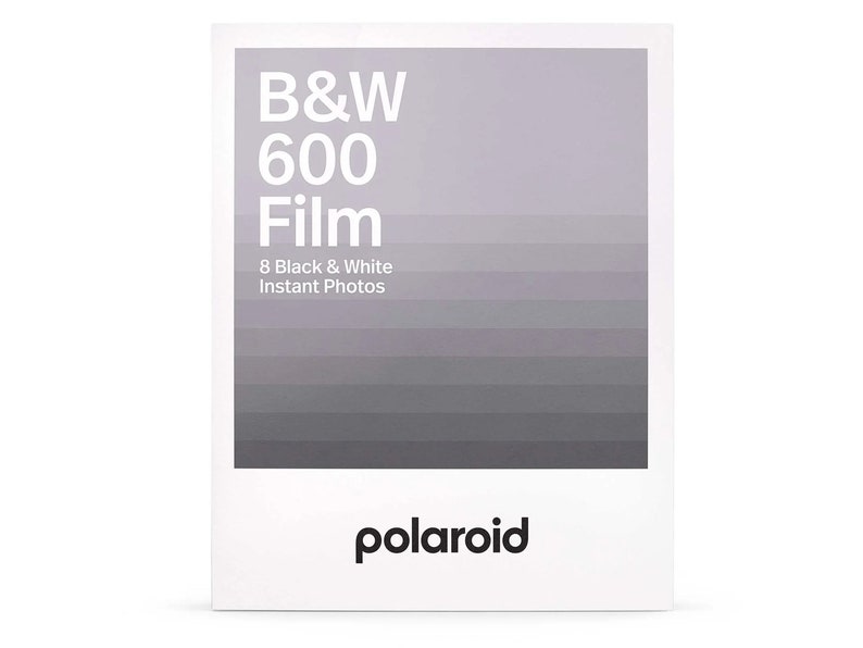 May include: A white box containing a Polaroid film pack in grey and white. The box features the text "B&W 600 Film" and "8 Black & White Instant Photos". The Polaroid logo is at the bottom of the box.