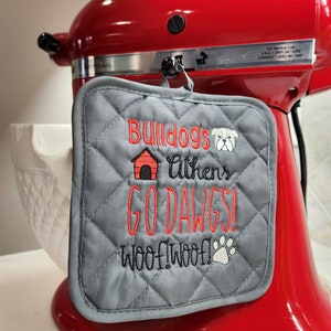 May include: Gray quilted oven mitt with red embroidered text that reads "Bulldogs Athens Go Dawgs! Woof! Woof!" and a red house and a white dog graphic.