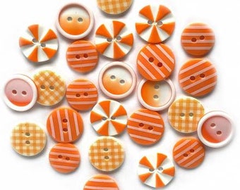 May include: A collection of 20 orange and white buttons with various patterns, including stripes, polka dots and gingham. The buttons are made of plastic and have a smooth finish.