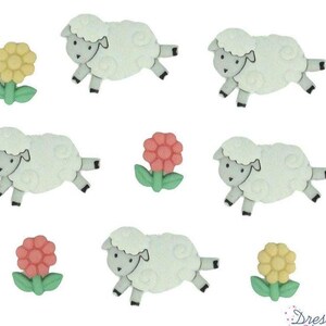 May include: A collection of four white sheep buttons with gray faces and legs, accompanied by three flower buttons in yellow and pink with green leaves. Each sheep is depicted in a side profile with textured wool, and the flowers have rounded petals.