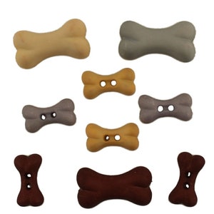 May include: Assortment of plastic dog bone buttons in various colors, including brown, beige, gray, and purple. The buttons have two holes each.
