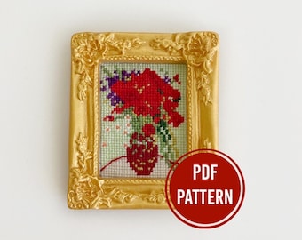 May include: A cross-stitch pattern of a red flower bouquet in a vase, framed in a gold frame. The text "PDF PATTERN" is on a red circle.