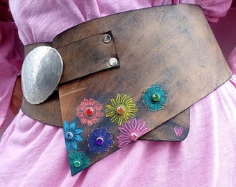 Wide leather belt decorated with flowers and studs.