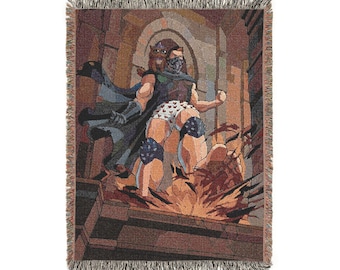 May include: A woven throw blanket featuring a colorful graphic illustration of a masked figure in a cape and patterned underwear standing in a stone archway. The scene includes a small creature on the figure's shoulder and an explosion at their feet.