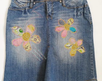Upcycled denim skirt with flowers, handmade patches, recycled denim, eco-friendly regenerated clothing, boho chic and indie style, size M