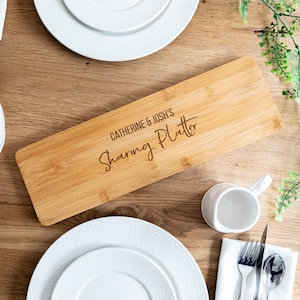 May include: A personalised bamboo serving platter with the text "Catherine & Josh's Sharing Platter" engraved on the surface.