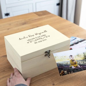 May include: A white wooden keepsake box with a hinged lid and a silver latch. The box is engraved with the text "Amelia Rose Weymouth Welcome to the World 11th July 2024".