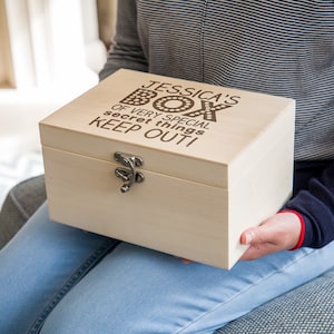 May include: A light wood box with a hinged lid and a latch. The box is engraved with the text "Jessica's Box of very special secret things KEEP OUT!"