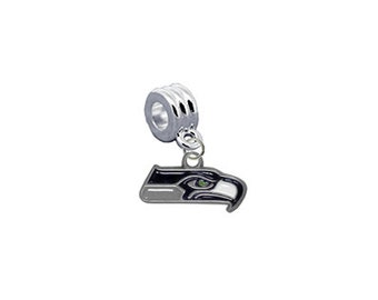 May include: Silver charm with a black and white Seattle Seahawks logo. The logo is an eagle's head with a green eye.