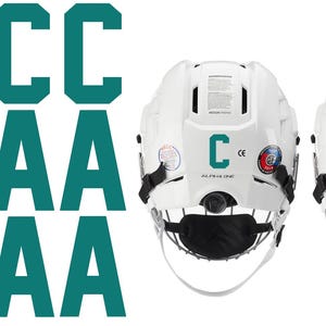 May include: White hockey helmets with teal "C" and "A" letters, along with matching letters. The helmets have black face masks and chin straps. The image also shows multiple teal "C" and "A" letters.