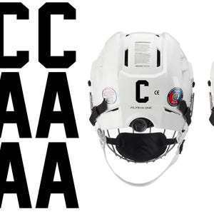 May include: White hockey helmets with black lettering, including the letters "C" and "A". The helmets have a black cage and chin strap. The image also shows multiple black "C" and "A" letters.
