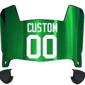 May include: A reflective emerald green football helmet visor featuring the white text CUSTOM and the number 00 centered on the front. The visor has a curved, contoured shape with two small black attachment clips positioned below the main shield.