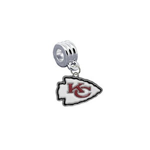 May include: Silver charm with a white arrowhead design featuring the red letters "KC" inside. The charm is designed to fit on a bracelet or necklace.