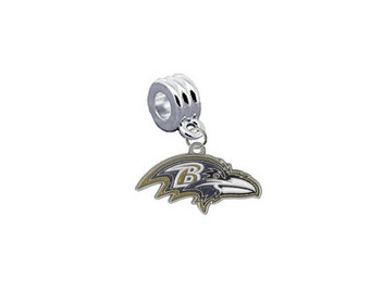 May include: Silver charm featuring a black and gold Baltimore Ravens logo. The logo depicts a raven with a "B" on its chest.