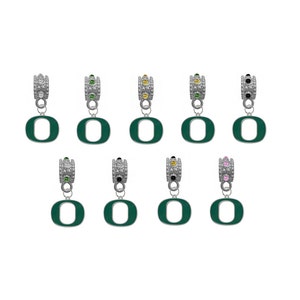 May include: Ten silver charm beads with green enamel letter 'O' charms. Each bead has a different colored crystal: black, green, yellow, light green, pink, and clear.