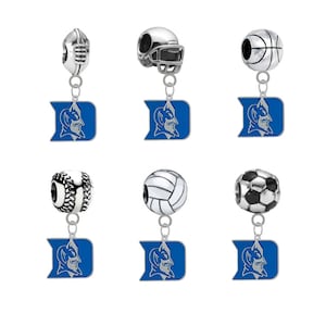 May include: Six silver charms with a blue and white Duke University logo. The charms feature different sports-themed designs, including a football helmet, basketball, baseball, soccer ball, and volleyball.