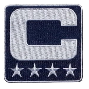 May include: Embroidered patch featuring a large white "C" on a navy blue background. The patch has four white stars at the bottom. The patch is square with a white border.