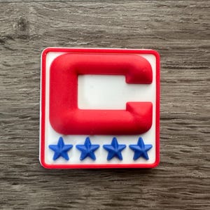 May include: Red and white patch with a large red "C" in the center and five blue stars at the bottom.