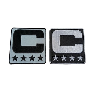 May include: Two embroidered patches, one black and gray, the other black and white. Each patch features a large letter "C" and five stars below. The patches are square with rounded corners.