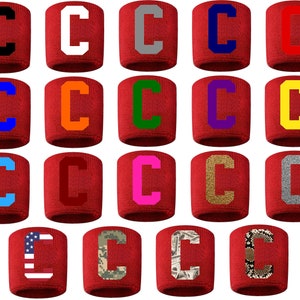 May include: Twenty red wristbands with a white letter C in various colors and patterns, including black, white, gray, blue, orange, green, purple, yellow, pink, gold, silver, American flag, camouflage, and money print.