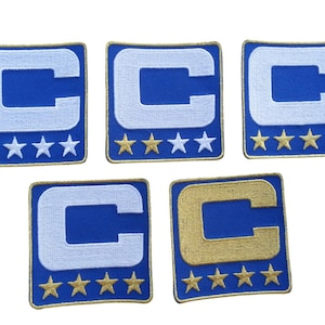 May include: Five embroidered patches featuring a blue background with a white "C" and gold stars. One patch has a gold "C". The patches are square with a gold border.